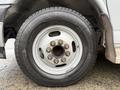 Close-up of a wheel and tire from a 2020 Chevrolet Express showing a silver rim and black tire with visible lug nuts