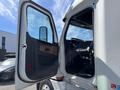 A 2022 Freightliner Cascadia with the driver's side door open showcasing the interior including the steering wheel and dashboard