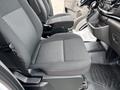 A 2023 Ford Transit driver seat with gray fabric upholstery and a patterned surface