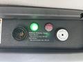 A control panel featuring a green indicator light a red indicator light and a button labeled FEB-11 with a message about methane detection status