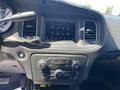 Dashboard of a 2019 Dodge Charger featuring a central infotainment screen and control knobs for climate and audio settings