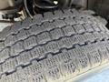 Close-up of a tire tread on a 2012 Ford F-350 SD showing a pattern designed for traction and control with visible wear indicators and grooves