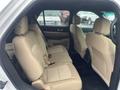 Interior view of a 2016 Ford Explorer showing the back row seats with beige upholstery and seating for three passengers