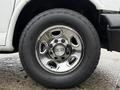 2009 Chevrolet Express with a shiny chrome wheel and tire showcasing a prominent Chevrolet logo on the hubcap