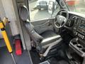 Interior view of a 2018 Chevrolet Express showing the driver's seat dashboard and control panel with a black leather seat and various controls