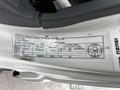 A label attached to a 2022 Isuzu NPR truck indicating vehicle specifications such as weight, tire pressure, and manufacturing details