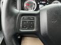 Steering wheel of a 2022 RAM 1500 Classic featuring control buttons for navigation and phone functions