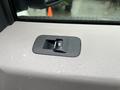 A close-up view of a power window switch on the door panel of a 2016 Ford F-150