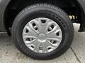 Close-up of a 2020 Ford Transit wheel featuring a silver alloy rim and a Firestone tire