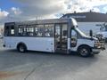 A 2018 Chevrolet Express designed as a shuttle bus with large side windows and multiple passenger seats visible inside