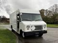 A white 2011 Ford Econoline cargo van featuring a large rectangular body and a front grille with a flat design and no visible logo