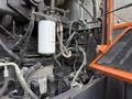 A 2018 Doosan DL300-5 loader showcasing the engine compartment with various hoses filters and mechanical components visible