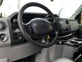 Interior dashboard of a 2011 Ford Econoline showing the steering wheel console and control panel