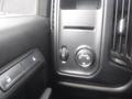 Control panel of a 2015 Chevrolet Silverado 1500 featuring buttons for locking doors and adjusting headlight settings