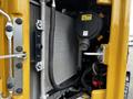 Close-up view of the engine compartment of a 2024 Caterpillar 306 highlighting the radiator and surrounding components
