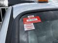 2007 Ford F-550 with a red certificate of approval sticker on the driver's side window displaying expiry information for January February and March