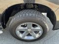 A close-up view of a chrome alloy wheel and tire from a 2011 RAM 1500 showcasing the tread pattern and wheel design
