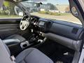 Interior view of a 2015 Toyota Tacoma showing front seats dashboard and center console with gear shift and controls