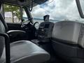 Interior view of a 2017 International WorkStar 7600 with gray seating and dashboard featuring various controls and a display screen