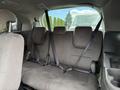 Interior view of a 2014 Honda Odyssey showing the back seat with three seat belts and a bench seat design