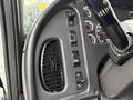 Dashboard controls of a 2005 Freightliner M2 106 featuring various switches and gauges with a steering wheel partially visible