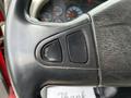 Close-up view of the black steering wheel of a 2011 International 4400 featuring control buttons on the left side