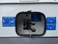 A panel on a 2014 Hino 195 showing two control levers for the ejector and tailgate, alongside safety instruction labels in blue