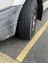 A 2010 Mercedes-Benz Sprinter with a flat tire on the front passenger side