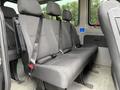 Interior seating of a 2017 Mercedes-Benz Sprinter with three rows of black upholstered seats equipped with seatbelts