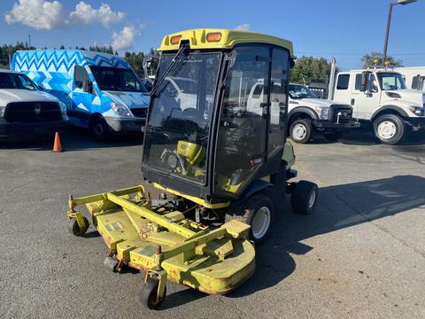 A 2010 Kubota F3680 tractor with a cab and a front-mounted mower attachment in a parking area
