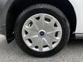 Close-up of a silver wheel rim on a 2016 Ford Transit Connect featuring multiple spokes and a branded hubcap with a black tire