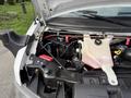A 2020 Chevrolet Express with the hood open showing the engine compartment including various components and fluid reservoirs