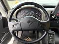 Steering wheel of a 2016 International 7600 with various gauges and controls visible on the dashboard