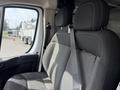 Front seating area of a 2017 RAM Promaster with grey fabric upholstery and seatbelt visible