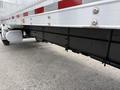 A 2022 International MV607 truck with a black undercarriage and silver accents visible underneath the trailer section