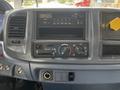 Dashboard of a 2006 Hino 268 with a radio, climate controls, and a compartment for storage