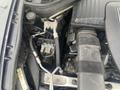 Close-up of the engine components of a 2009 BMW X5 showing various pipes wires and a module in a compact space