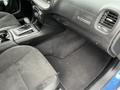 Interior view of a 2022 Dodge Charger showing the front seats center console and dashboard with controls and a gear shift