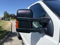 Side view mirror of a 2014 Ford F-250 SD featuring a black casing and an orange reflect strip