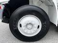 Close-up of a wheel on a 2012 International DuraStar 4300 featuring a large black tire with the label Good Year and a silver rim with six bolt holes