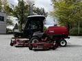 A red 2012 Toro Groundsmaster with dual rotary mowers attached at the front designed for mowing large grass areas