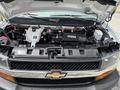Engine compartment of a 2020 Chevrolet Express showing various components like the battery hoses and air intake system
