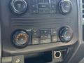 Dashboard controls of a 2017 Ford F-350 SD featuring climate control knobs and buttons for air conditioning and ventilation settings