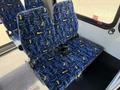 A blue patterned fabric seat with a seatbelt designed for passenger use in a vehicle