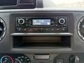A dashboard of a 2022 Ford Econoline featuring a radio display and various control buttons