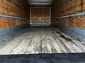 Interior cargo area of a 2020 Hino 338 truck with a wooden floor and plywood walls