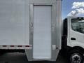 A 2018 Hino 195 truck with a closed side door on its cargo area and visible front cab