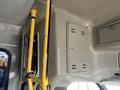 Interior view of a 2012 Chevrolet Express showing yellow grab bars and panels on the ceiling