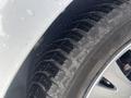Close-up of a tire from a 2017 Ford Transit Connect showing tread pattern and rim details