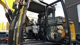 A 2018 Caterpillar 326F L Excavator with an open cab showing the seat control panel and interior details of the operator's area